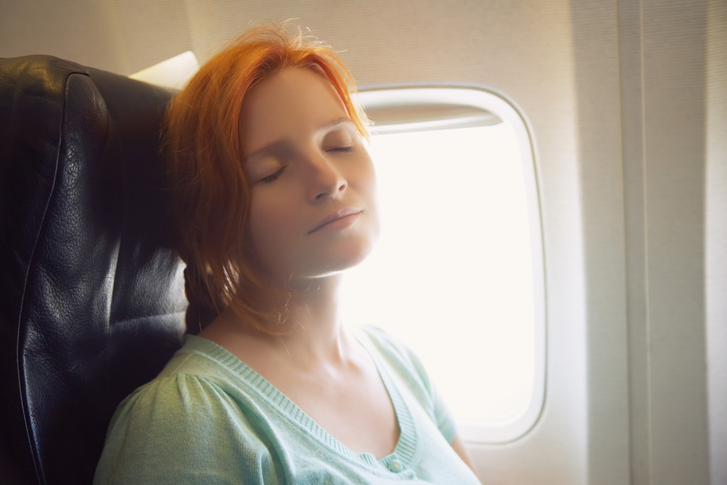 woman sleeping while onboard an aircraft