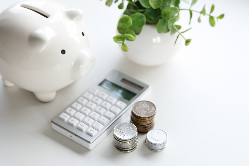 Piggy bank, coins, and calculator