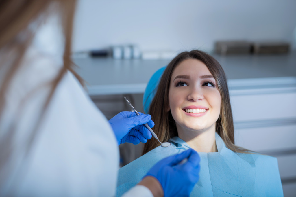 cheerful woman in dental clinic for a checkup or procedure