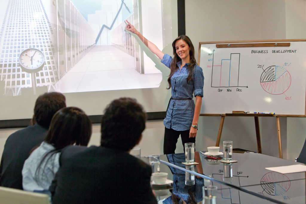 A woman presenting in a conference room