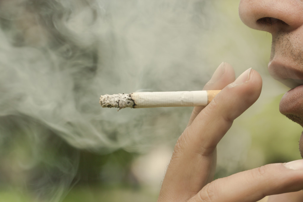 Close up image of a man having a cigarette