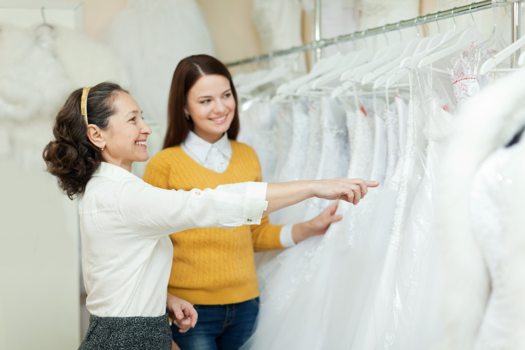 A woman selecting a wedding dress for her upcoming wedding