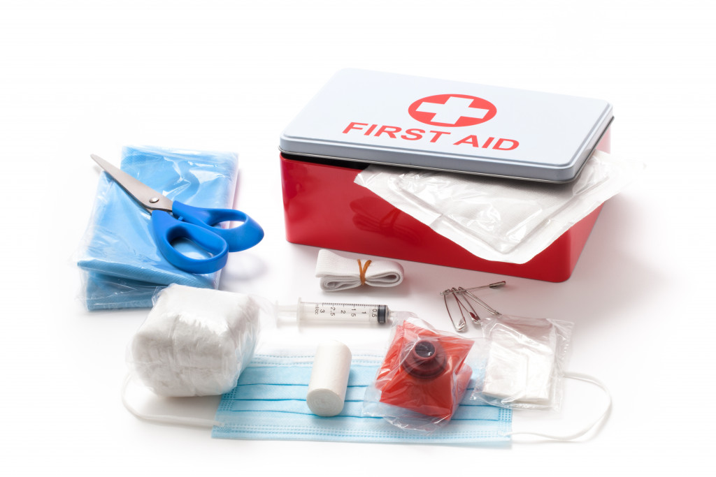 first aid kit with standard supplies on white background
