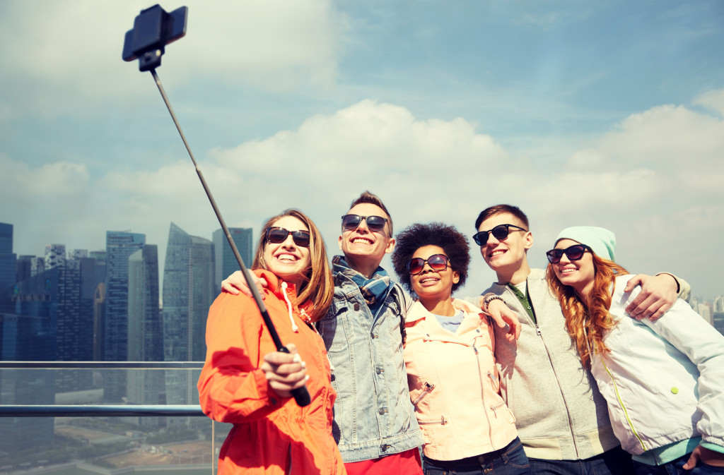 happy travelers posing for a group selfie