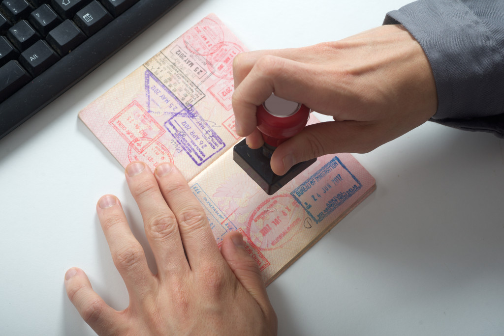 immigration control officer with arrival stamp on passport