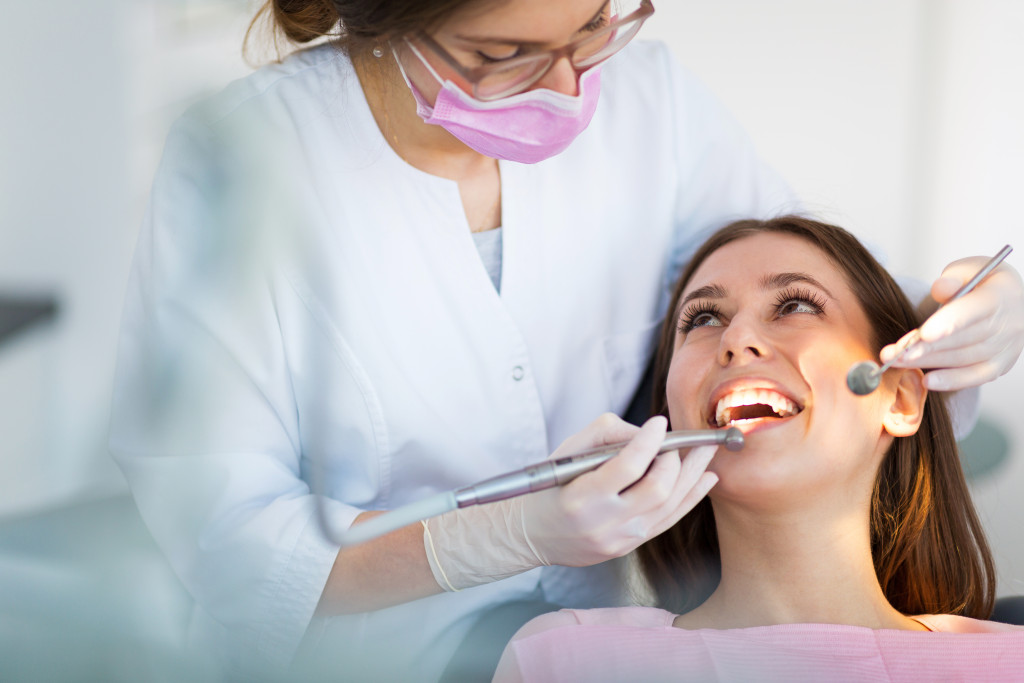 a woman on a dental chair getting a dental treatment