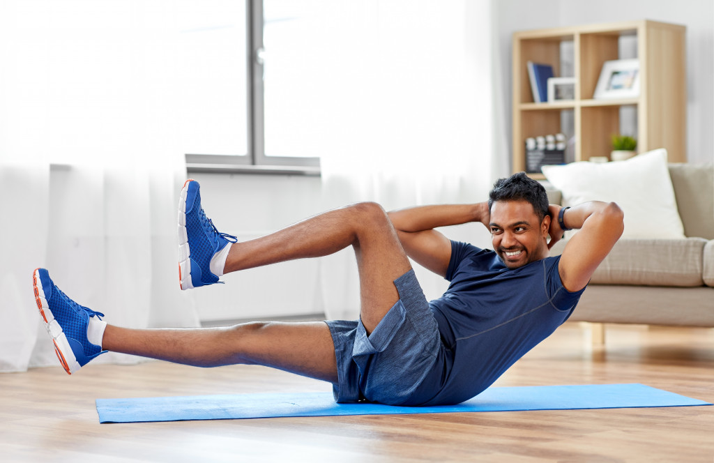 A man exercising on a yoga mat