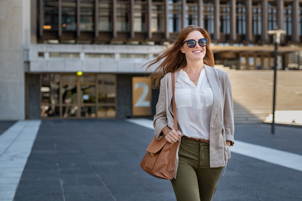 successful woman walking on street wearing casual formal clothes