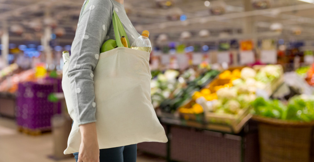 woman using sustainable bag for shopping locally